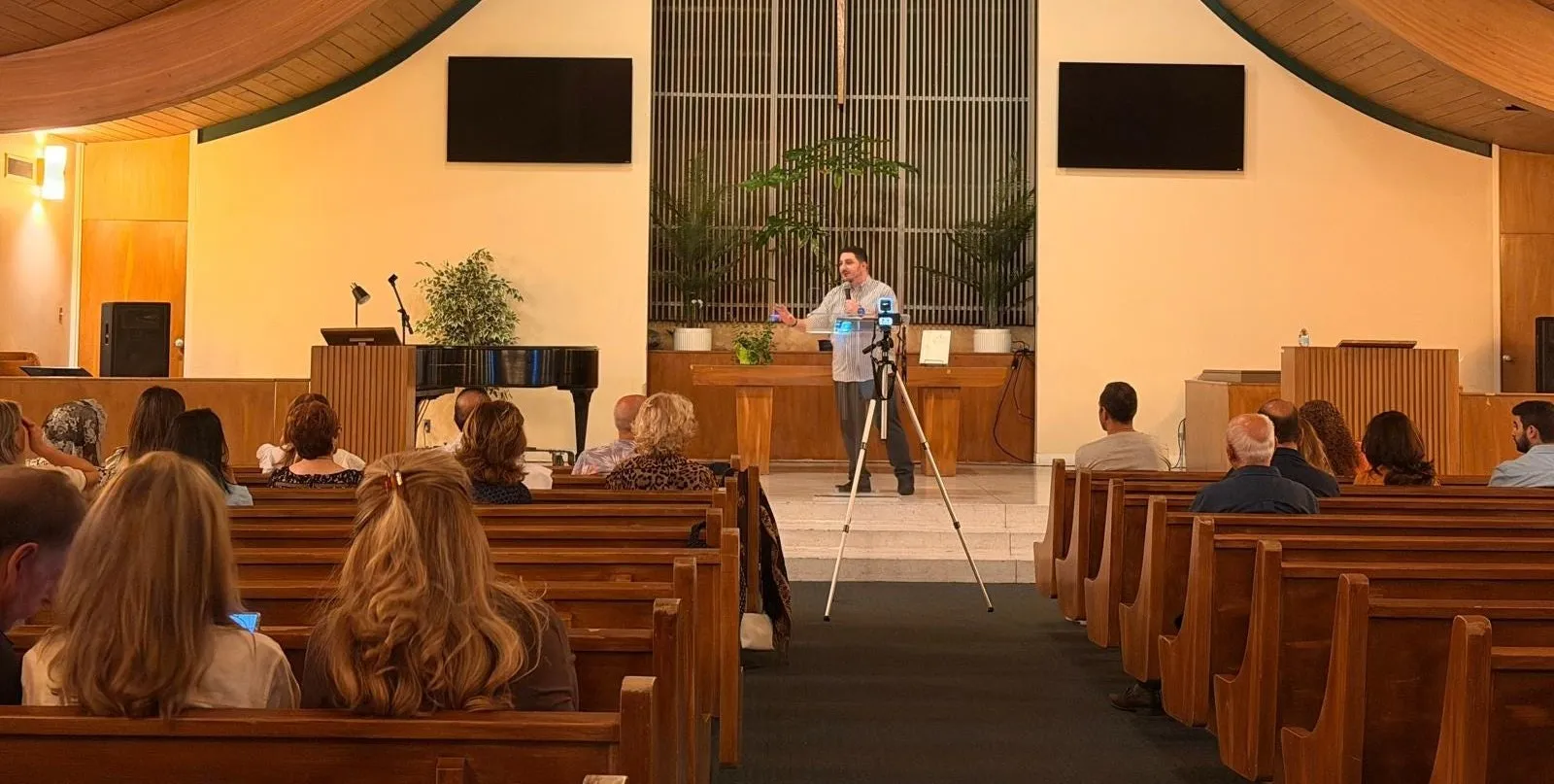 A speaker addressing a congregation in a church sanctuary